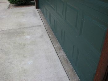 Garage slab and driveway showing settling that can be corrected with concrete raising